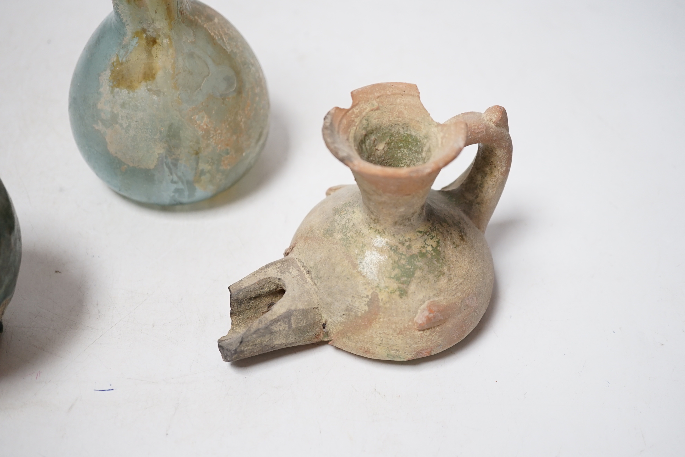 A Roman glass vessel, an Islamic pot and oil lamp, largest 18cm high (3)